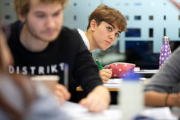 Students diligently working in a cafe.